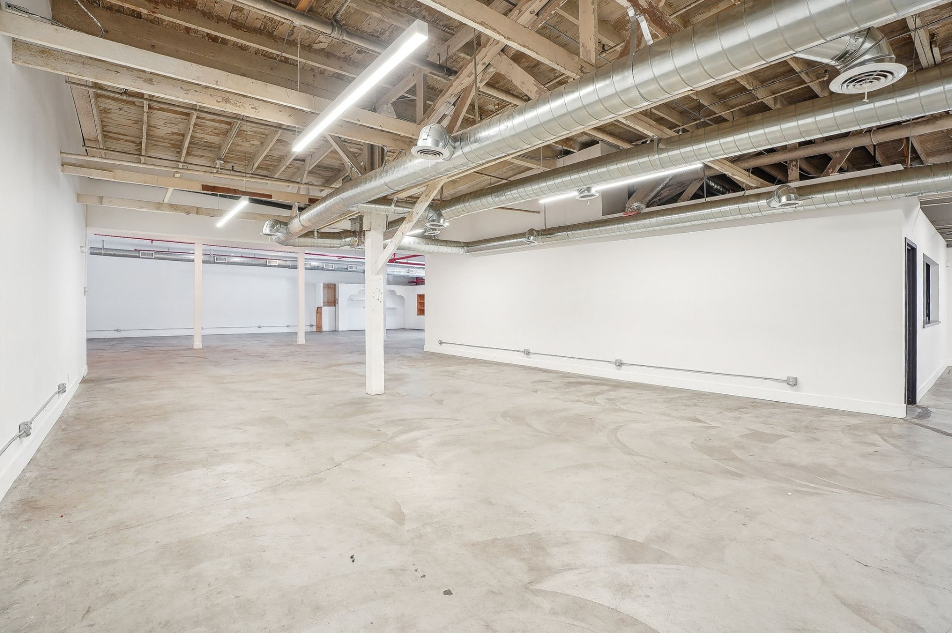 Bright open floor plan with long white walls ready for build-out
