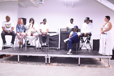 Panel discussion on stage with guests seated